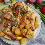 Chicken tabaka with potatoes in the oven