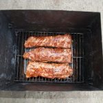 Smoking pork ribs in a smokehouse