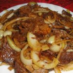 Meat with onions in a frying pan